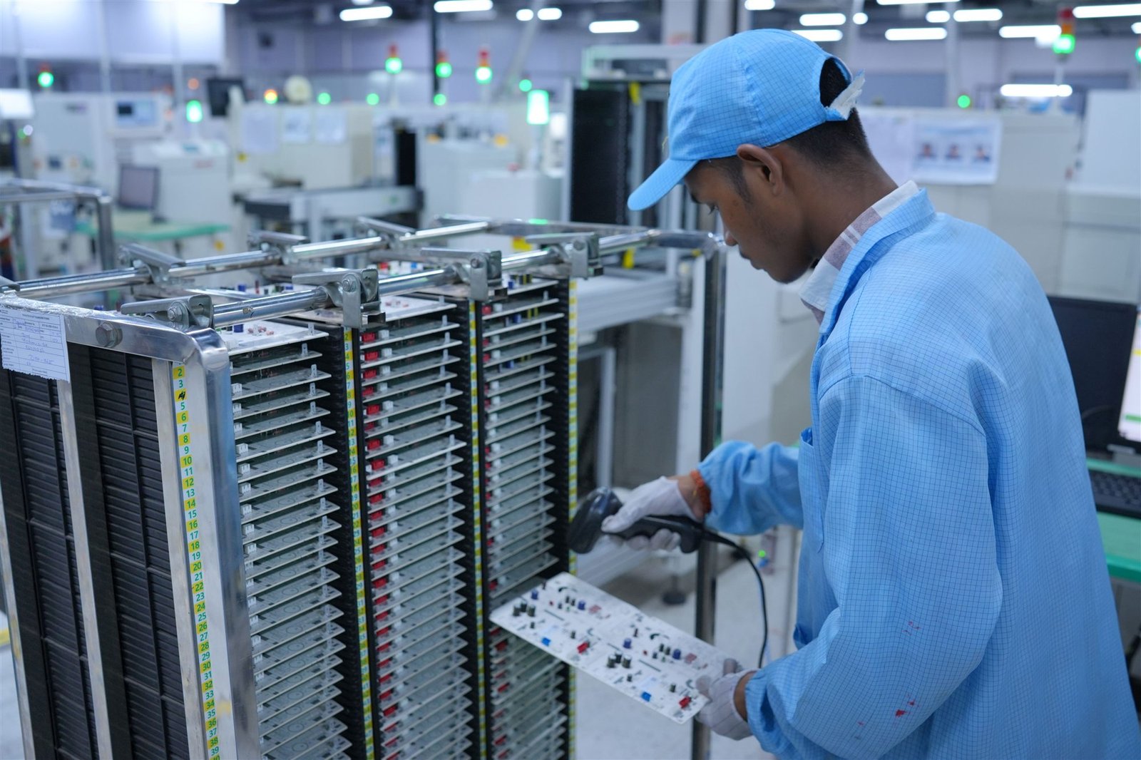 PCT quality technician inspecting a printed circuit board