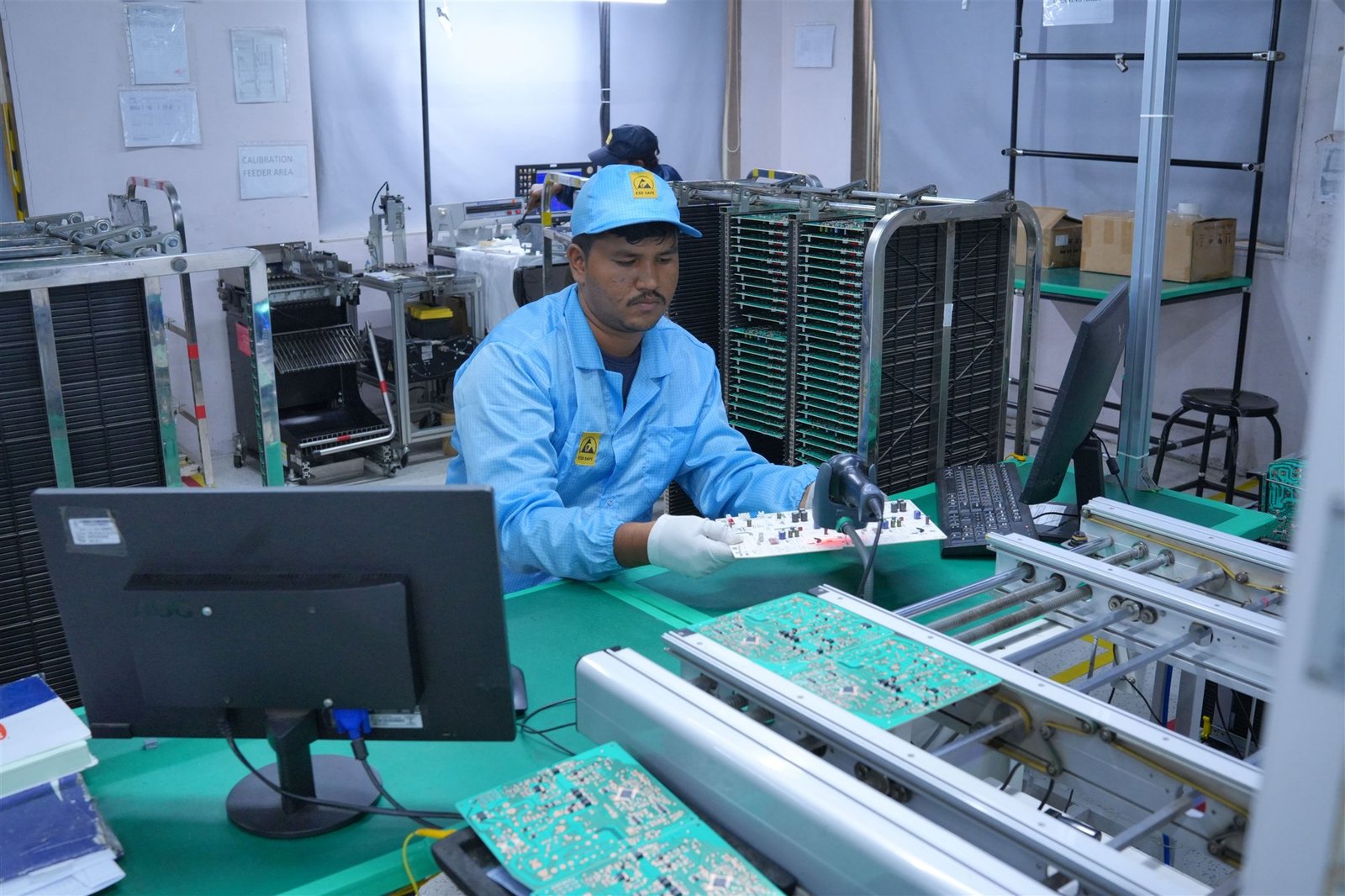 PCT quality technician inspecting printed circuit boards